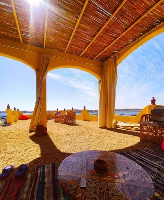 a pavilion on the beach with a view of the ocean at Wanas Kato Guest House in Shellal