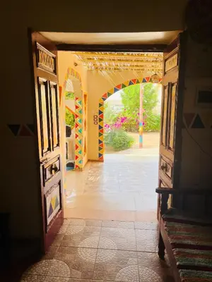 an open door into a room with a courtyard at Wanas Kato Guest House in Shellal