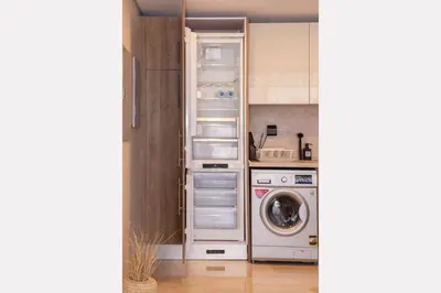a kitchen with a refrigerator and a washing machine at Earthy & Tranquil 1 BDR Mangroovy Free Pool & Beach Access in Hurghada