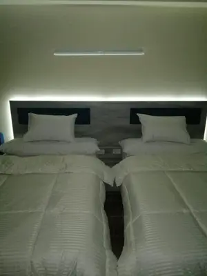 two beds sitting next to each other in a bedroom at florenza khamsin studio in hurghada pool view in Hurghada