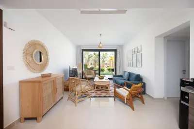 a living room with a blue couch and chairs at VESTA - El Gouna Residence in Hurghada