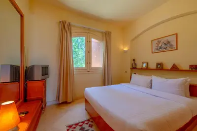a bedroom with a white bed and a window at VESTA - El Gouna Residence in Hurghada