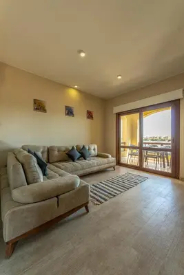 a living room with two couches and a balcony at VESTA - El Gouna Residence in Hurghada