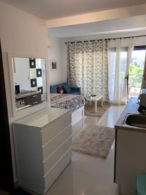 a kitchen and living room with a bed and a sink at G cribs B1F2 in Hurghada