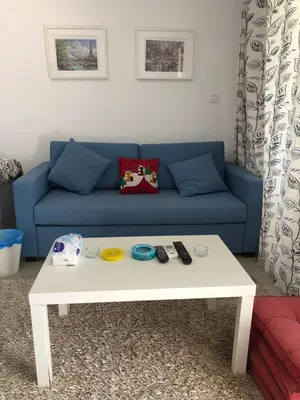 a blue couch with a white coffee table in a living room at G cribs B1F2 in Hurghada