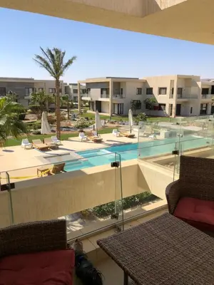 a view of a swimming pool from the balcony of a resort at G cribs B1F2 in Hurghada