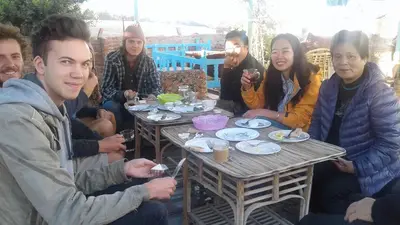 a group of people sitting around a wooden table at Sea Waves Hostel not for Egyptian in Hurghada
