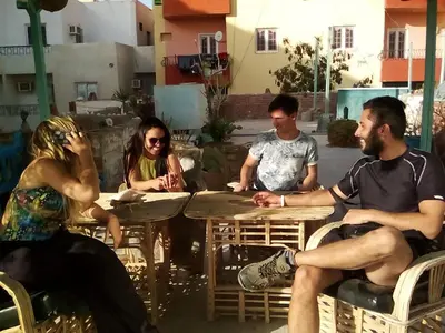a group of people sitting around a table at Sea Waves Hostel not for Egyptian in Hurghada