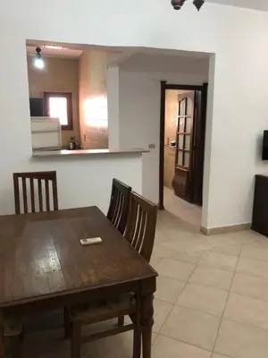 a dining room with a wooden table and chairs at The LOTUS in Hurghada