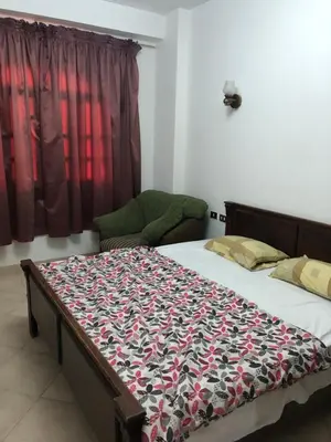 a bedroom with a bed with a blanket on it at The LOTUS in Hurghada