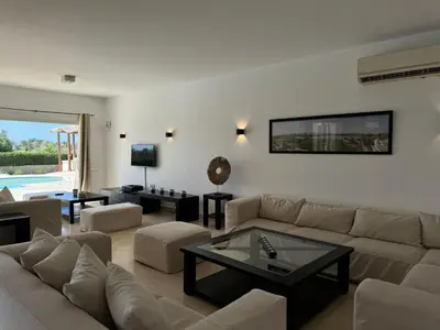 a living room with a couch and a table at Villa with 5 bedrooms & 4 bathrooms - private heated pool in Hurghada
