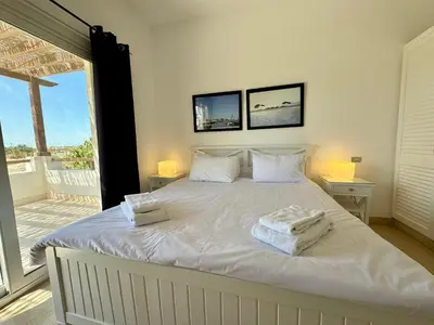 a bedroom with a white bed with towels on it at Villa with 5 bedrooms & 4 bathrooms - private heated pool in Hurghada