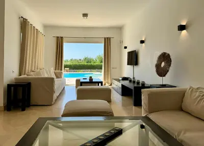 a living room with a couch and a table at Villa with 5 bedrooms & 4 bathrooms - private heated pool in Hurghada