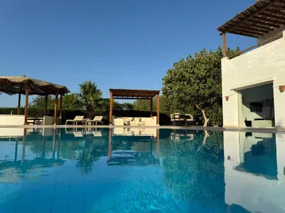a swimming pool with blue water in a house at Villa with 5 bedrooms & 4 bathrooms - private heated pool in Hurghada