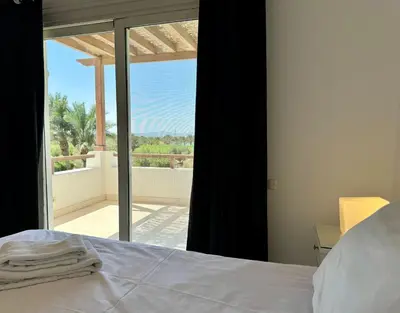 a bedroom with a bed and a view of a balcony at Villa with 5 bedrooms & 4 bathrooms - private heated pool in Hurghada