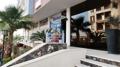 a building with a sign on the side of it at Aqua Palms Studio A210 in Hurghada