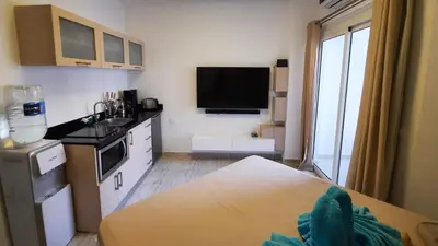 a small kitchen with a sink and a counter top at Aqua Palms Studio A210 in Hurghada