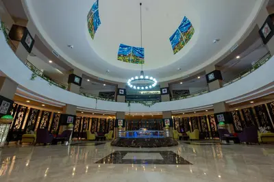a large lobby with a large fountain in the middle at El Karma Beach Resort & Aqua Park - Hurghada in Hurghada