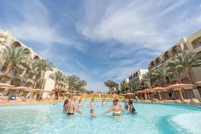 a group of people in the swimming pool at a resort at El Karma Beach Resort & Aqua Park - Hurghada in Hurghada
