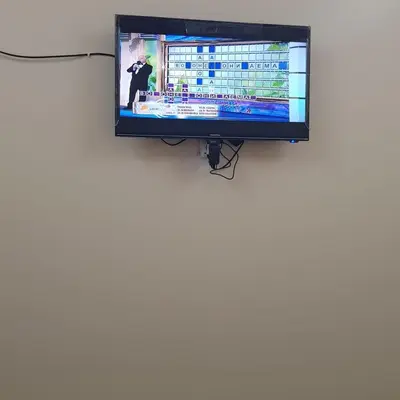 a flat screen tv hanging on a wall at Sweet Home 5 Open 24 Hour in Hurghada