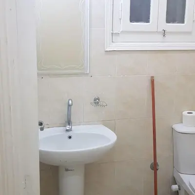 a bathroom with a sink and a window and a toilet at Sweet Home 5 Open 24 Hour in Hurghada