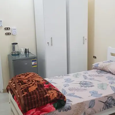a bedroom with a bed with a blanket on it at Sweet Home 5 Open 24 Hour in Hurghada