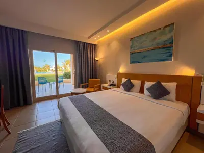 a hotel room with a bed and a large window at Sataya Resort Marsa Alam in Marsa Alam City