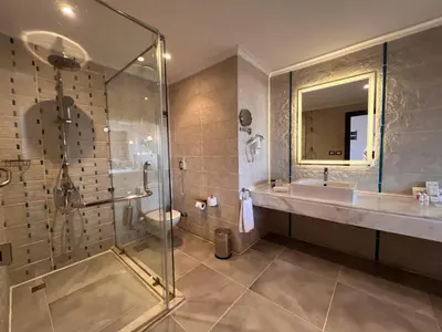 a bathroom with a shower and a sink and a toilet at Sataya Resort Marsa Alam in Marsa Alam City