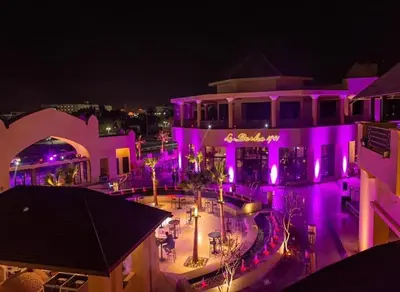 a building with purple lights on it at night at AlDau Hights one Bedroom Elegante Apartment 10201 in Hurghada