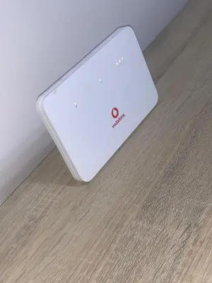 a white laptop sitting on top of a wooden floor at AlDau Hights one Bedroom Elegante Apartment 10201 in Hurghada