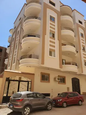 two cars parked in front of a building at Abeer Suites in Hurghada
