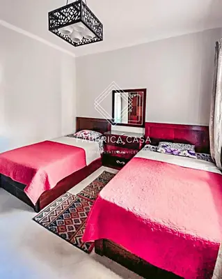 a bedroom with two beds and a mirror at Comfy apt by Sentido Marsa Alam in Marsa Alam City