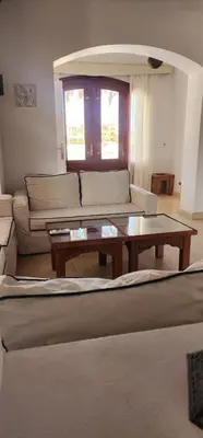a living room with a couch and a coffee table at Nayah Stays, Lagoons beach, Paradise 3 ensuite with private pool in El Gouna