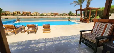 a swimming pool with a bunch of chairs and a table at Nayah Stays, Lagoons beach, Paradise 3 ensuite with private pool in El Gouna