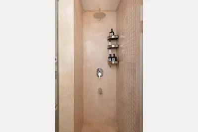 a shower in a bathroom with a glass door at Epic & Exquisite 2 BR w Beach & Pool Mangroovy in Hurghada