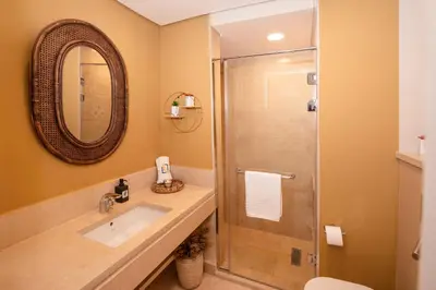 a bathroom with a sink and a shower at Epic & Exquisite 2 BR w Beach & Pool Mangroovy in Hurghada