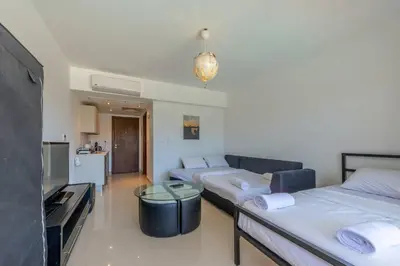 a living room with two beds and a couch at Cozy Studio in G-Cribs with pool - Golden Apartments El Gouna in Hurghada