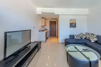 a living room with a large flat screen tv at Cozy Studio in G-Cribs with pool - Golden Apartments El Gouna in Hurghada