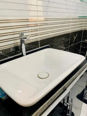 a white sink in a bathroom with a mirror at Chalet stella makadi family only in Hurghada