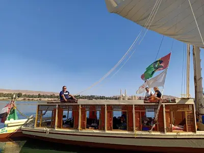 a boat with people on it on the water at JJ Jamaica Felucca in Aswan