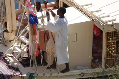 a man standing on the side of a house at JJ Jamaica Felucca in Aswan