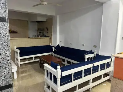 a living room with two beds and a table at SWEET HOSTEL LUXOR in Luxor