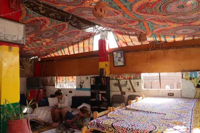 a woman and a child sitting in a room at SWEET HOSTEL LUXOR in Luxor