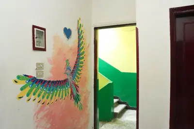 a painting of a peacock on a wall at SWEET HOSTEL LUXOR in Luxor