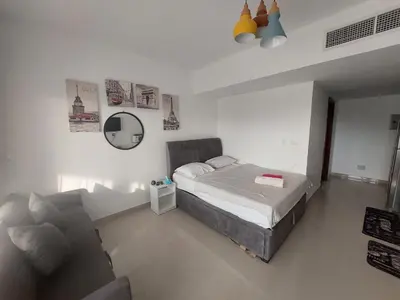 a bedroom with a bed and a couch in it at Renovated Lovely Cozy Studio in G Cribs, Elgouna in Hurghada