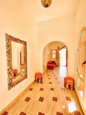 a room with a mirror and a room with two beds at FabbricaCasa Sea Front Villa, Oriental Coast in Marsa Alam City
