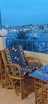 a couple of chairs and a table on a balcony at Masa Nubian House in Aswan