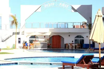 a hotel with a swimming pool and a building at Tiba View - Unit no B15 - near ElGouna in Hurghada