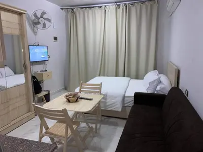 a room with a bed and a table and a couch at Tiba View - Unit no B15 - near ElGouna in Hurghada