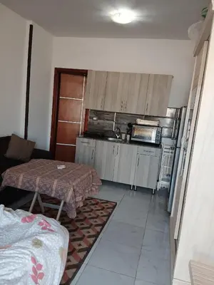 a small kitchen with a table and a microwave at Tiba View - Unit no B15 - near ElGouna in Hurghada